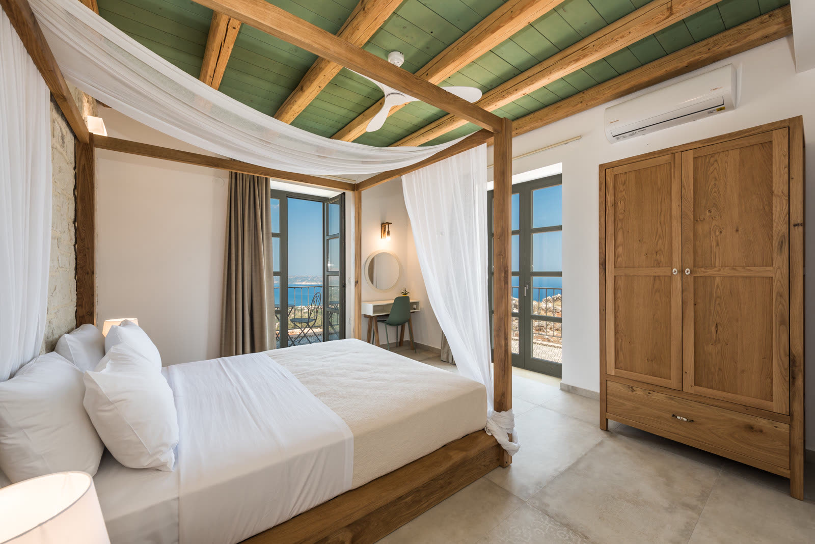Four-poster double bedroom with sea-view balcony doors